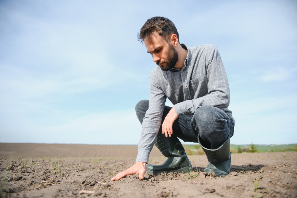 Soil expert examining stabilized ground in a Texas field
