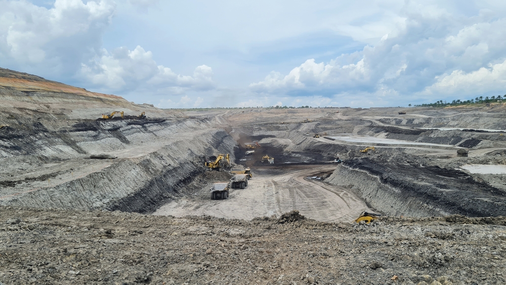 Large excavation site with heavy equipment preparing ground for stabilization
