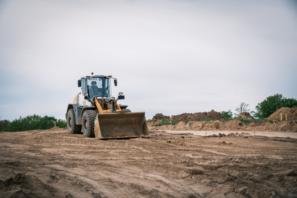 Wheel loader grading prepared soil at a Texas construction site